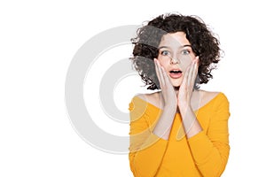 Shocked teenager screaming in disbelief, isolated over white background. Surprised young girl waist up studio shot.