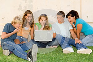 Shocked teens with laptop