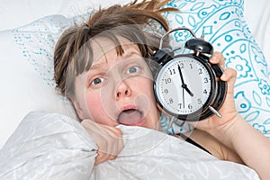 Shocked woman comes late to work because she oversleep photo