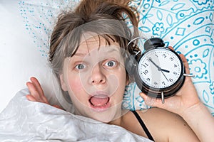 Shocked woman comes late to work because she oversleep photo