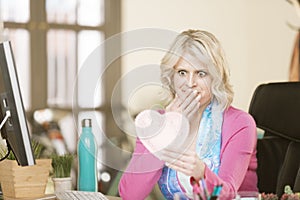 Shocked Woman in her Office with a Valentine Heart