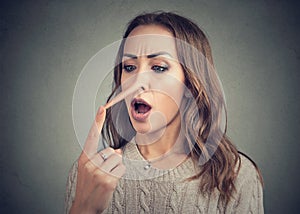 Shocked woman with long nose of liar