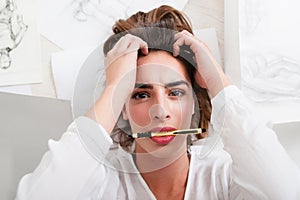 Shocked woman look at camera with pencil in mouth