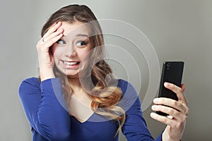 Shocked woman look at phone