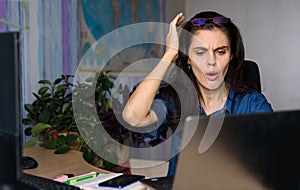 Shocked woman looking at laptop screen feel bad surprise annoyed reading online news frustrated with stuck computer