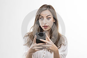 Shocked woman looking at phone, Young girl shocked looking at mobile