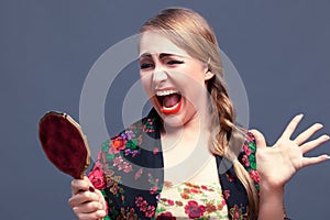 Shocked woman in a with mirror