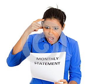 Shocked woman with monthly statement