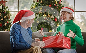 Shocked woman receiving present from husband