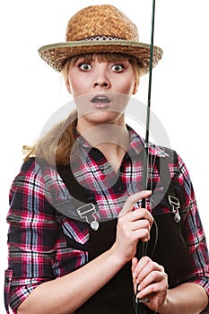 Shocked woman in sun hat holding fishing rod