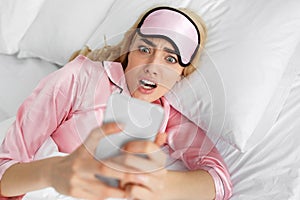 Shocked woman wakes up with anxiety, bad news and oversleep photo