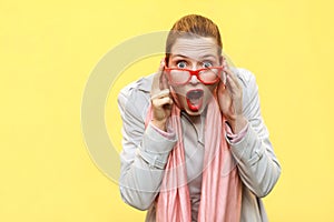 Shocked woman wearing coat, pink scarf, opening mouths , having