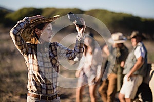 Shocked woman holding binoculars during safari vacation