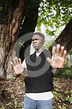 Shocked young 20s African man doing no stop sign with palms of hands