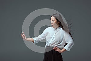 shocked young asian woman holding smartphone