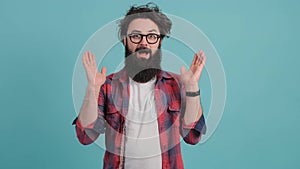 Shocked young bearded man with joyful expression, achievement.