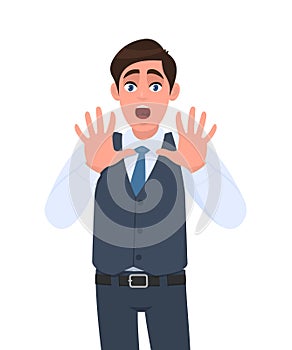 Shocked young businessman shouting and making stop gesture with hands. Trendy person afraid and terrified with fear expression.