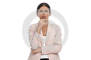 Shocked young businesswoman crossing arms and opening mouth