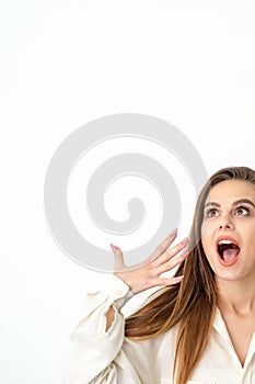 Shocked young caucasian woman with open mouth looking up and expresses surprise isolated over white background