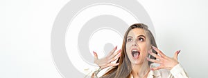 Shocked young caucasian woman with open mouth looking up and expresses surprise isolated over white background
