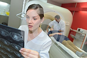 Shocked young female doctor reviewing mri