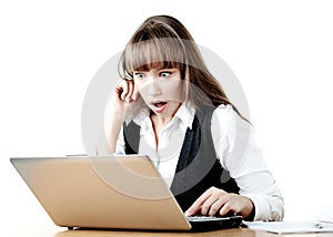 Shocked young girl is looking at a laptop