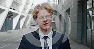 Shocked young redheaded business man in classical suit looking at the camera in surprise. Can't believe the terrible