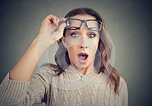 Shocked young woman in eyeglasses