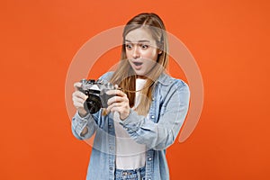Shocked young woman girl in casual denim clothes posing isolated on orange background studio portrait. People sincere
