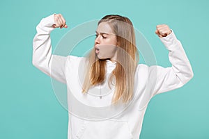 Shocked young woman girl in casual white hoodie posing isolated on blue turquoise background studio portrait. People
