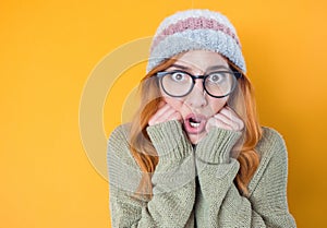 Shocked young woman, isolated on yellow background. Astonished girl. Bad news