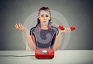 Shocked young woman receiving bad news on the phone