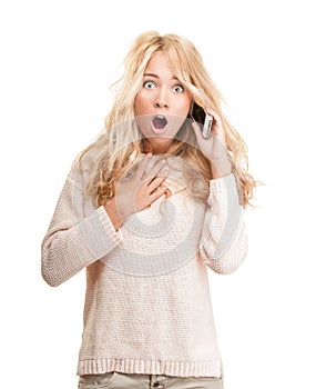 Shocked young woman talking on phone on white.