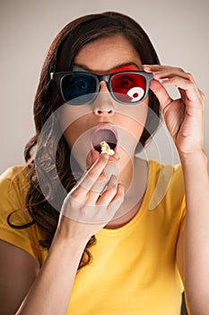 Shocked young woman watching 3D movie