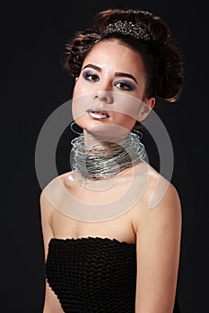 Shocking beauty portrait of cheeky young woman with wire necklace.
