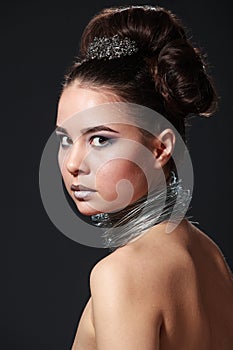 Shocking beauty portrait of cheeky young woman with wire necklace.