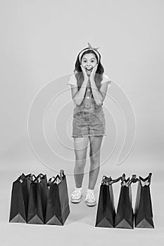 Shocking discount. Shopping day. Fashion boutique. Girl shopping. Fashion shop. Little girl with shopping packages