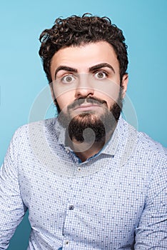 Shocking news. Studio portrait of a much surprised young man. The beard