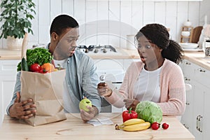 Shocking Prices. Frustrated African American Family Checking Bills After Grocery Shopping