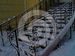 Shod black staircase covered with snow