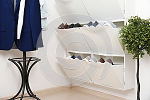 Shoe cabinet with footwear in room.