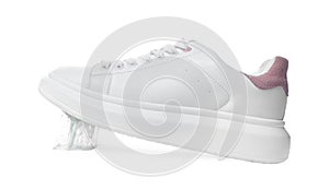 Shoe with chewing gum on sole against white background