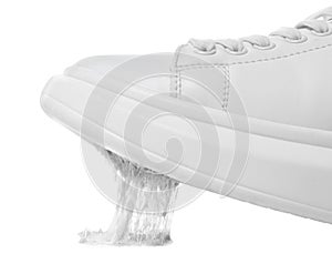 Shoe with chewing gum on sole against white background, closeup