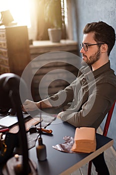 Shoe designer having a rest while sitting at workplace