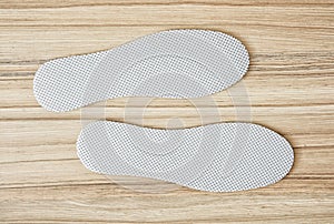 Shoe insoles on the wooden background