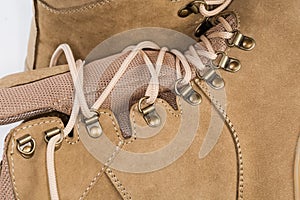 Shoe lacing of beige leather combat boots, fragment close-up