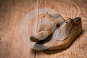 Shoe Lasts on the brown wooden background. Retro style