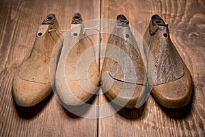 Shoe lasts on wooden background.