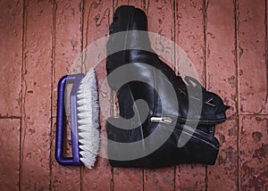 Shoe Polishing with female legs in black boots