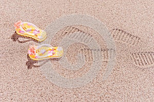 Shoe prints of flip flops at the beach